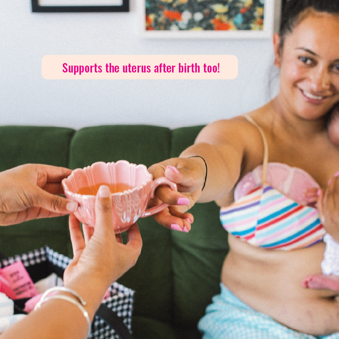 Postpartum mom holding a baby with a raspberry leaf tea 