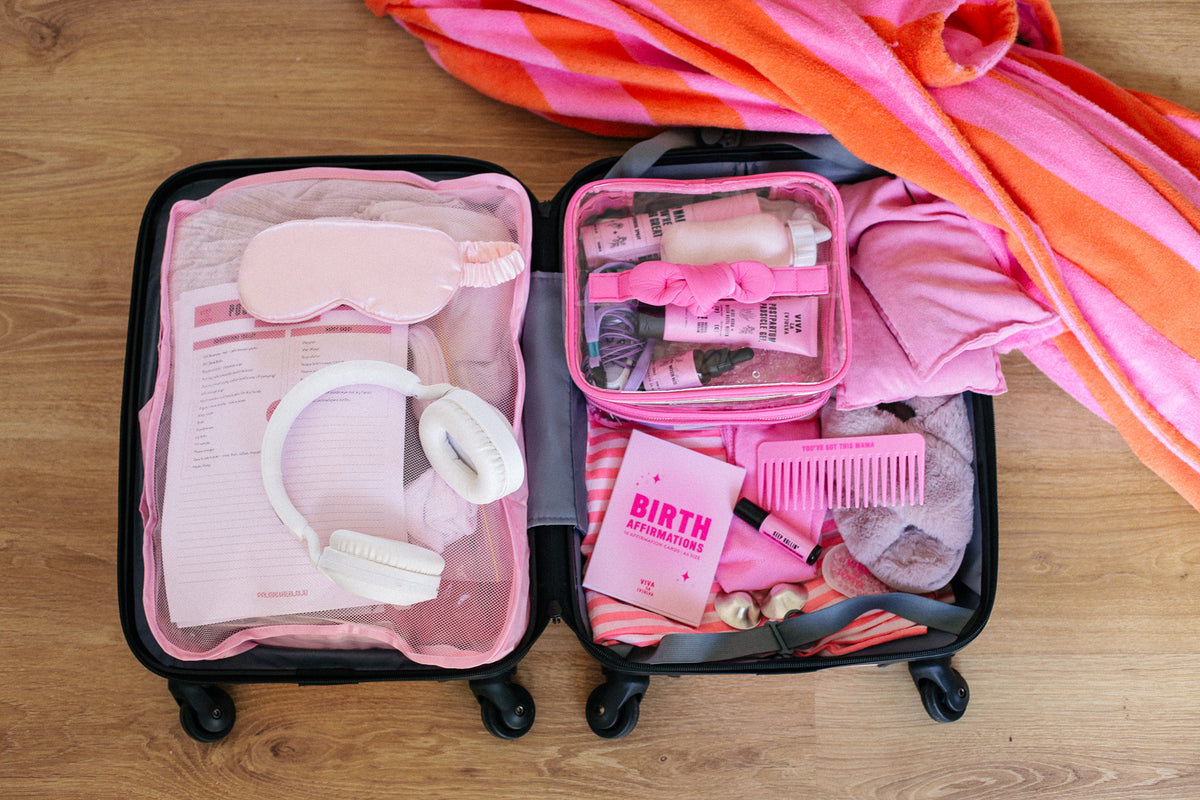 Hospital bag packed with Viva La Vulva postpartum essentials in a pink suitcase - Viva La Vulva NZ